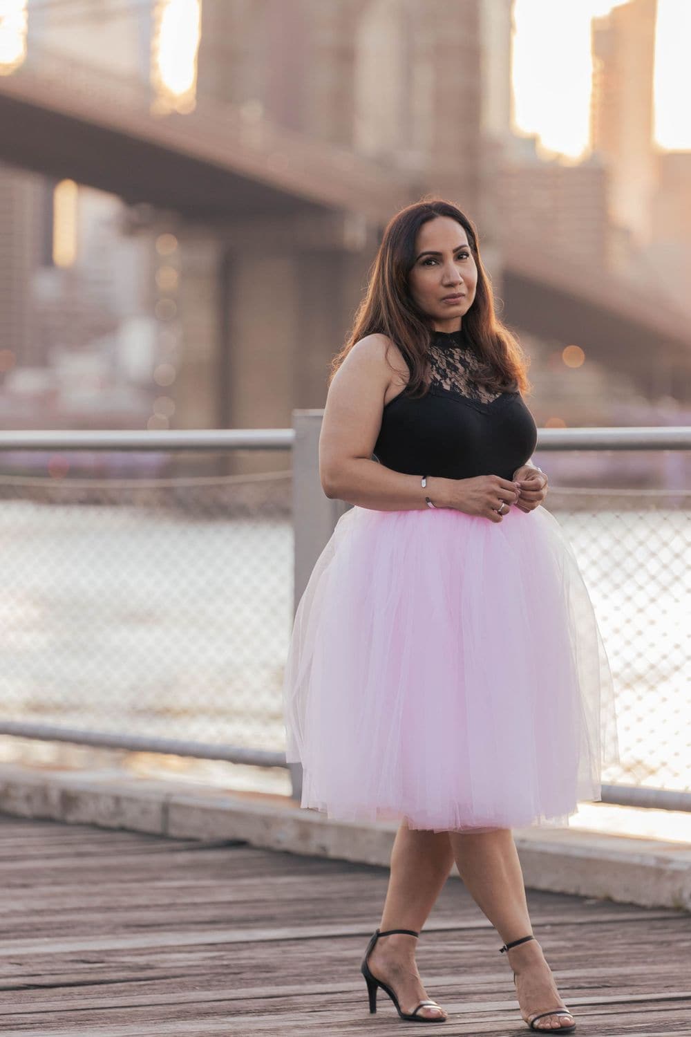 Confident birthday portrait in a pink tutu at the Brooklyn Bridge, directed by Create With Amy