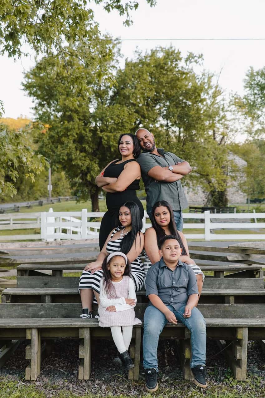 Laughing multigenerational family photo session on wooden benches by Create With Amy in Harford County, Maryland