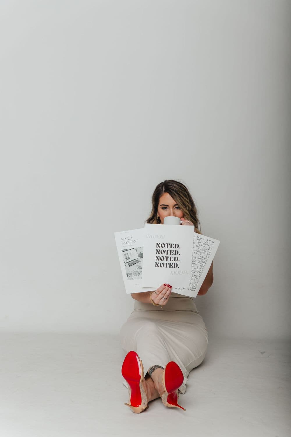 Business owner brand session on a clean backdrop with printed brand materials, by Create With Amy, professional headshots and brand photos in Baltimore