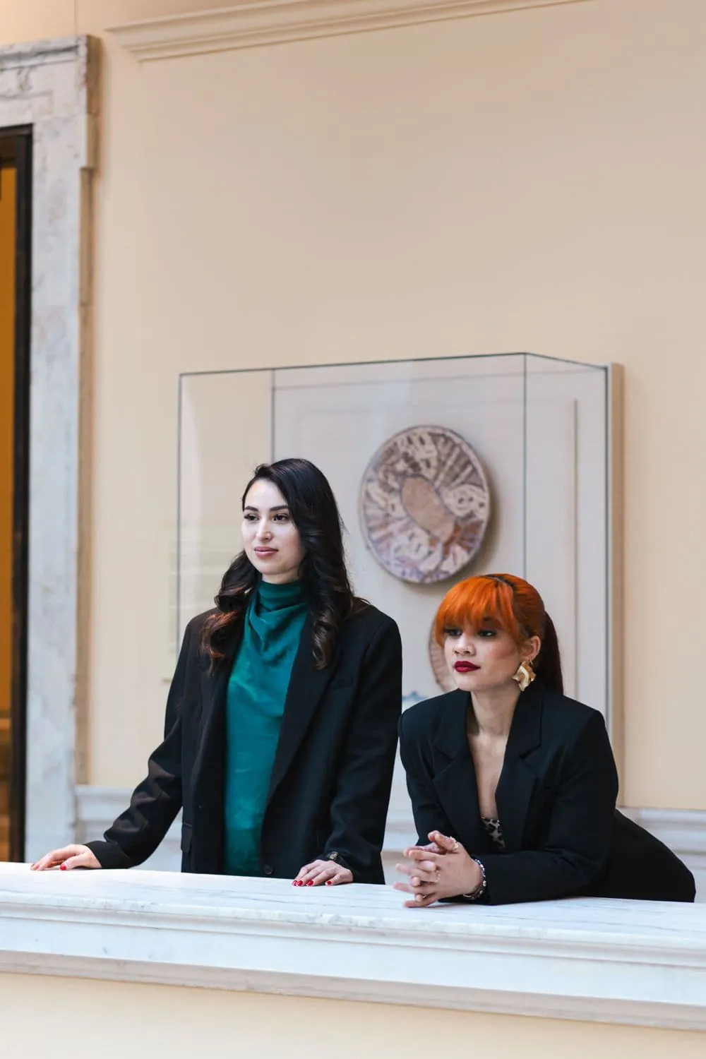 Two business owners in professional portraits at a marble balustrade, photographed by Create With Amy, Baltimore headshot photographer