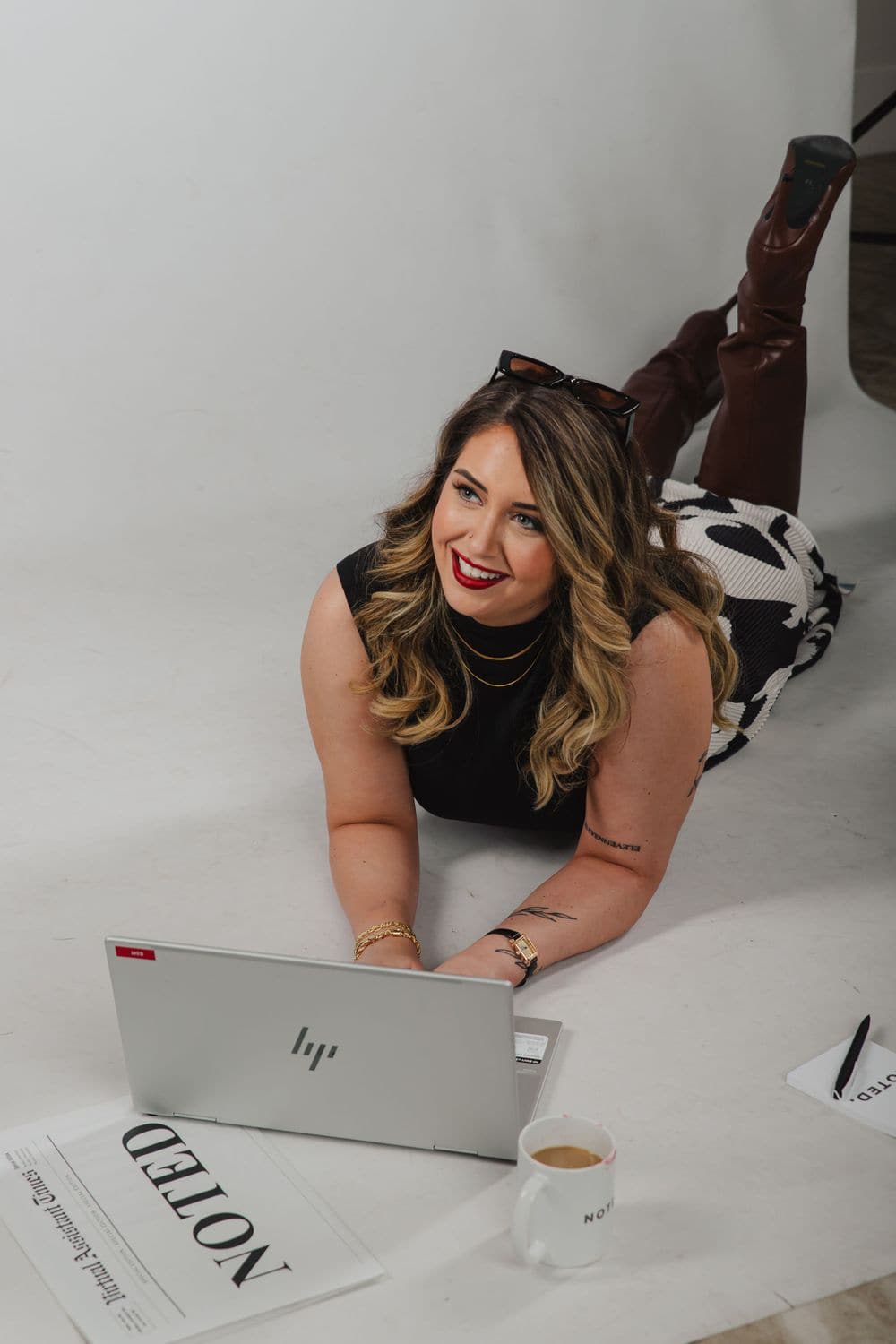 Business owner filming playful brand content on a backdrop with her laptop, from a Create With Amy content session in Baltimore